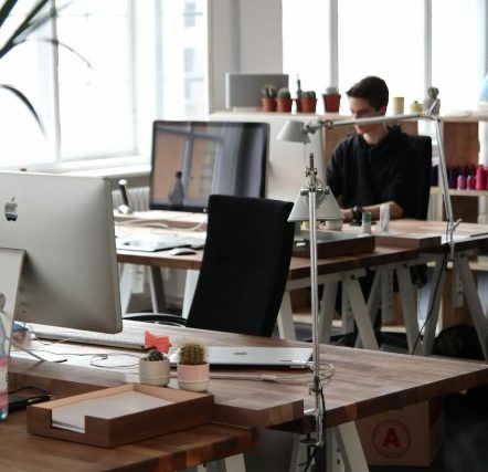 Man Sitting in Front of Computer in his office