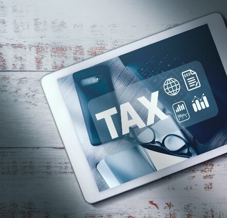 Top view of digital tablet with math finance interface of TAX on screen and copy space